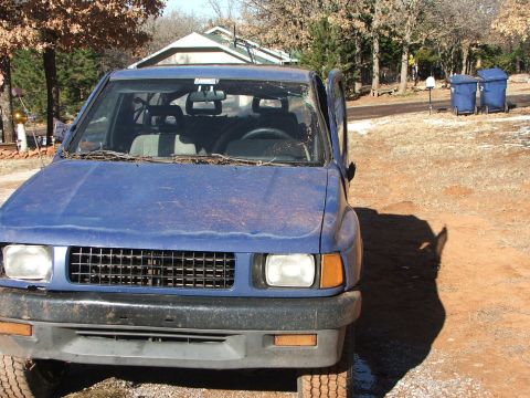 1990 Dodge Shadow - This blue SUV is seen from the front, showing its grille and headlights.
