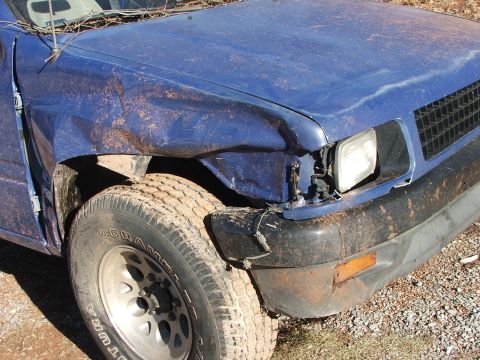 1990 Dodge Shadow - This blue SUV has sustained heavy damage to its front right side, including the fender and bumper.
