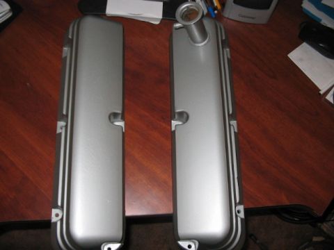 1991 Ford Bronco - A pair of silver valve covers are displayed on a desk surface.