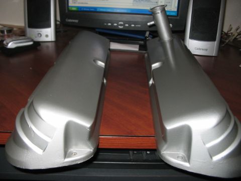 1991 Ford Bronco - Two silver valve covers are displayed on a desk, likely for an engine swap or modification.