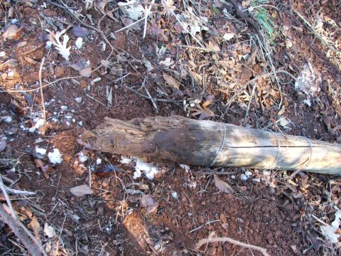 1990 Dodge Shadow - The image shows a ground scene with debris and a broken wooden post, not a vehicle.