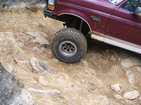 1993 Ford Bronco - A maroon 1993 Ford Bronco navigates a challenging rocky trail.