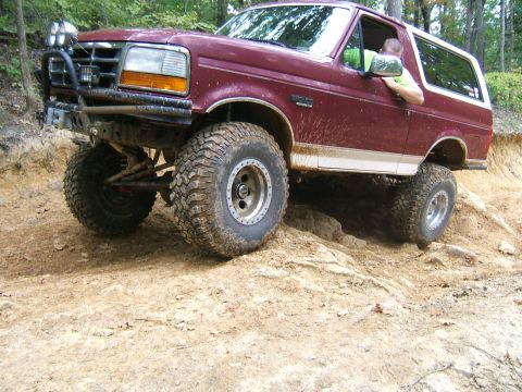 1993 Ford Bronco - This 1993 Ford Bronco navigates a challenging off-road course with large tires and lifted suspension.