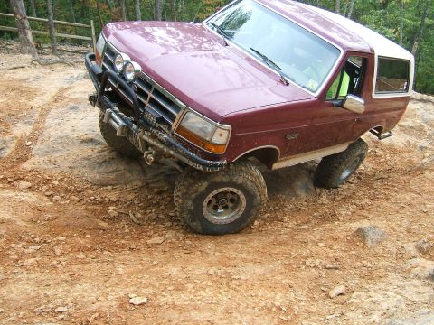 1993 Ford Bronco - This 1993 Ford Bronco navigates a challenging rocky terrain with one wheel lifted.