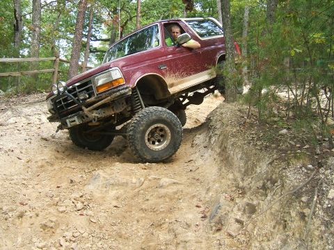 1993 Ford Bronco - This 1993 Ford Bronco tackles a challenging off-road course, demonstrating its capabilities on a steep, rocky incline.