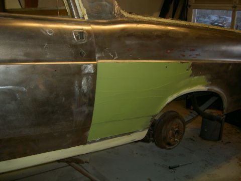 1967 Ford Ranchero - Side view of a car's bodywork undergoing repairs, showing metal and filler.
