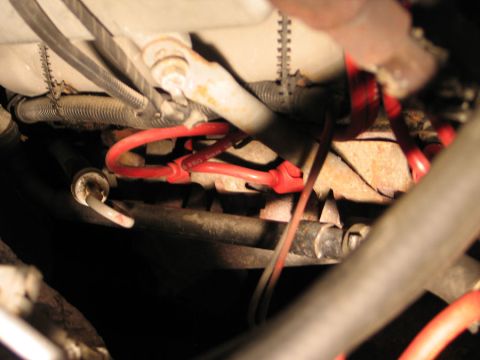 1994 Ford Bronco - Close-up view of spark plug wires and engine components, with visible rust.