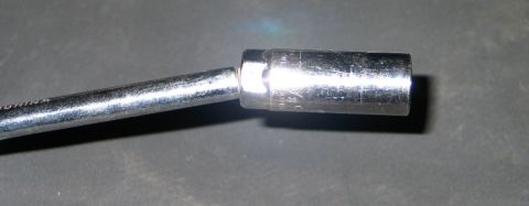 1994 Ford Bronco - A close-up view of a socket wrench extension, showing some engraved text on the socket itself.