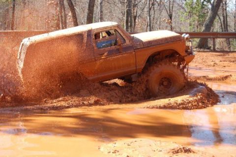 1992 Ford Mustang - Ford Bronco deep in mud during off-road excursion.