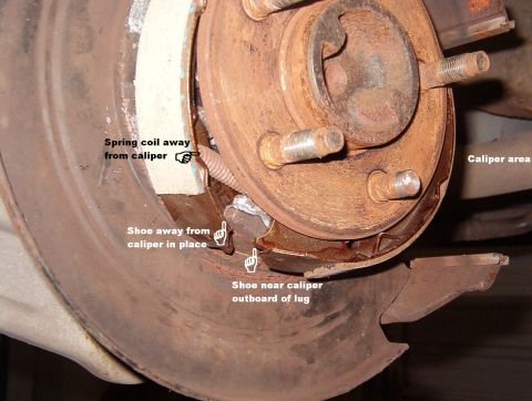 1999 Ford Crown Victoria - Transfer the lower spring to the new shoes & replace them in the reverse order. Set the bottom of the far shoe into the notches on the lug…