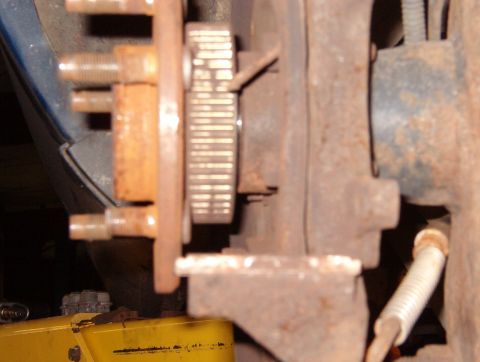 1999 Ford Crown Victoria - Rotate the hub so there's ample clearance behind the stud to be removed, then drive it inward with a hammer until its splines clear the hub…