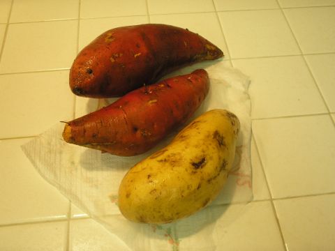 1966 Ford Bronco - A collection of sweet potatoes and a potato are displayed on a paper towel against a tiled background.