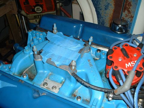 1985 Ford Bronco - This photo shows a close-up of an engine's intake manifold, with blue tape applied to parts of it.