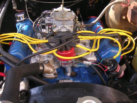 1979 Ford F-250 - The engine bay features a V8 engine with prominent yellow spark plug wires and a red distributor cap.