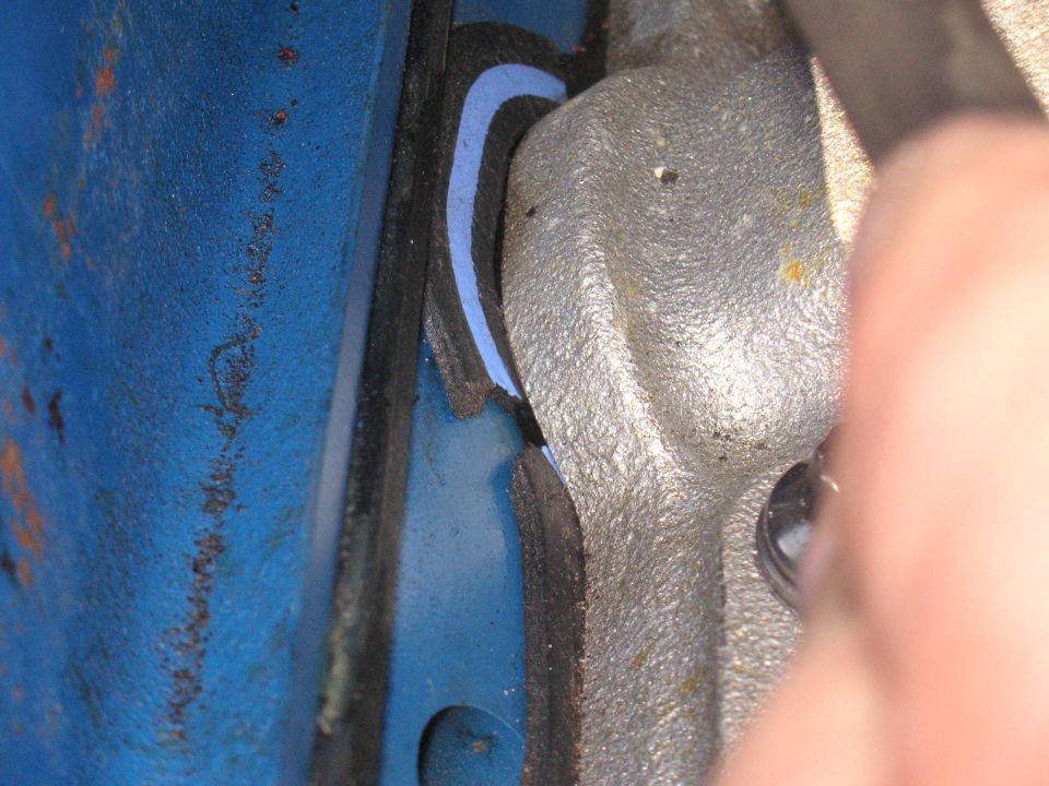 Close-up of engine part with blue gasket material visible