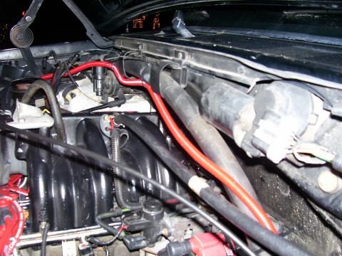 1996 Ford Bronco - The engine bay of a 1996 Ford Bronco is visible, with a focus on the intake manifold and associated wiring and hoses.