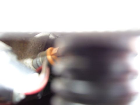 1996 Ford Bronco - A blurry view of engine bay components, including hoses and wiring, with a watermark at the bottom right.