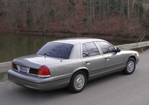 2001 Ford Crown Victoria - Rear three-quarter view of a silver 2001 Ford Crown Victoria parked outdoors.