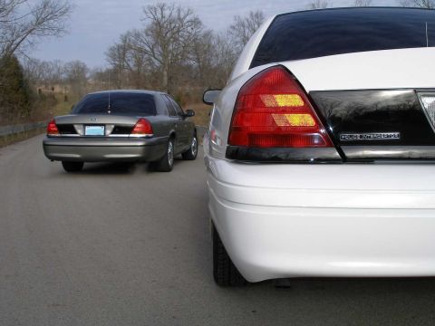 2001 Ford Crown Victoria - Two Ford Crown Victoria Police Interceptors seen on the road.