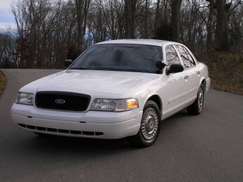 2001 Ford Crown Victoria - A white 2001 Ford Crown Victoria is shown from a three-quarter front view on a paved road.
