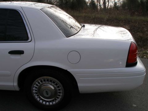 2001 Ford Crown Victoria - Rear view of a white 2001 Ford Crown Victoria showing the quarter panel and wheel.