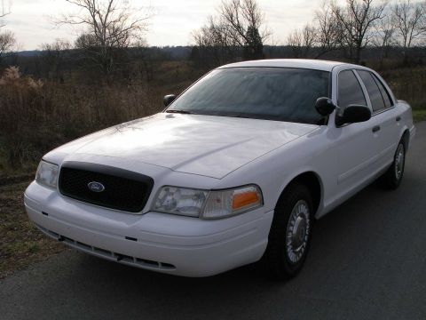 2001 Ford Crown Victoria - A white Ford Crown Victoria is shown from the front quarter angle, parked outdoors.