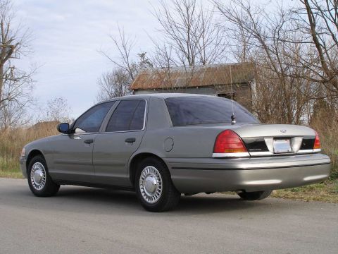 2001 Ford Crown Victoria - Rear view of a gray 2001 Ford Crown Victoria sedan parked outdoors.