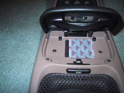 1994 Ford Bronco - The interior of a vehicle's center console is open, revealing a small packet with repeating text and graphics.