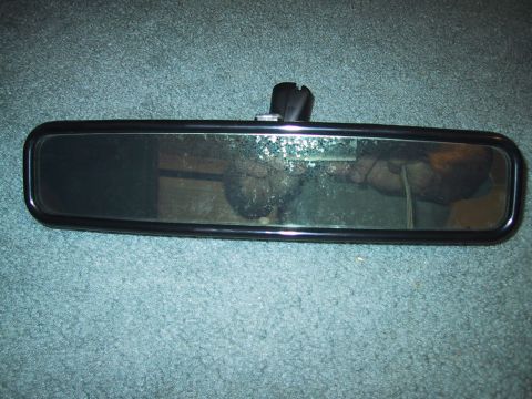 1994 Ford Bronco - Interior rear view mirror with black frame and mounting bracket.
