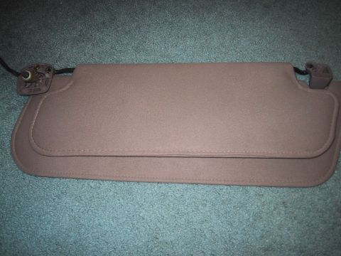 1994 Ford Bronco - A tan sun visor is shown, detached from a vehicle, with its mounting hardware visible.