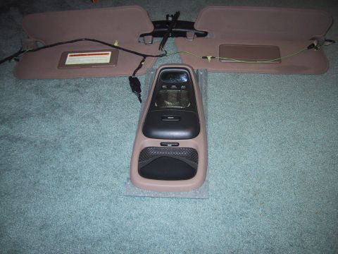 1994 Ford Bronco - Overhead console and sun visors removed from a vehicle, with wiring visible.