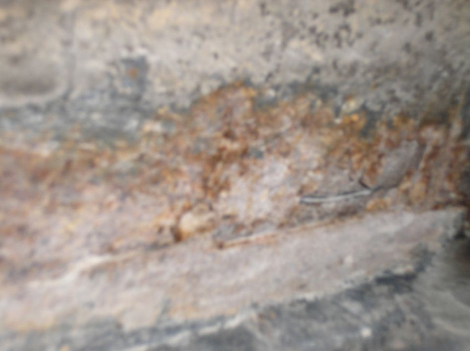 Close-up of rusted metal with Supermotors logo