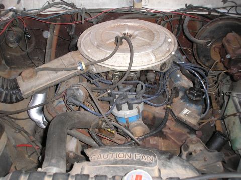 1978 Ford Bronco - A close-up view of a vehicle's engine bay, showing various components and wiring.