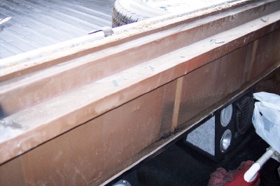 1972 Ford Ranchero - View of the interior of a pickup truck bed, showing speakers installed beneath a wooden paneling structure.