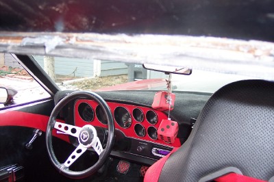 1972 Ford Ranchero - The custom interior features a red dashboard with multiple gauges, an aftermarket steering wheel, and red fuzzy dice.