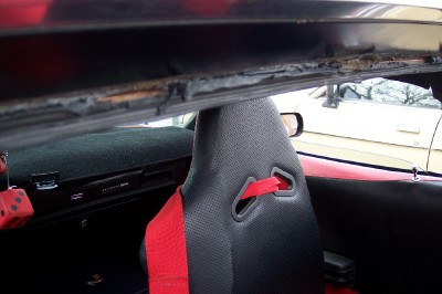 1972 Ford Ranchero - Interior view of a car with racing seats and fuzzy dice. Another vehicle is seen outside.