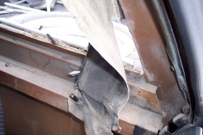 1972 Ford Ranchero - Close-up view of damaged interior trim and a seatbelt in a vehicle.