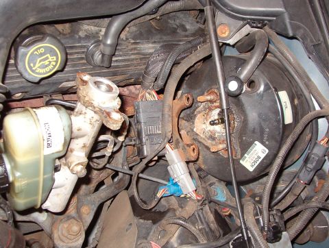 1999 Ford Crown Victoria - Move the wiring harness connector bracket off the studs, then pull the master cylinder forward to allow clearance for the booster. The brak…