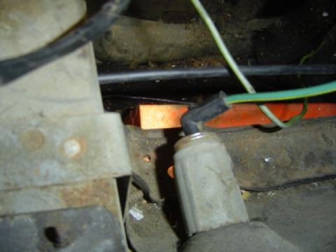 1979 Ford Bronco - Close-up view of an engine wiring harness with visible green and black wires and connectors.