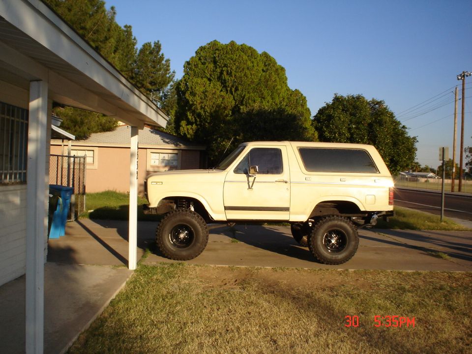 Lifted cream-colored SUV side view