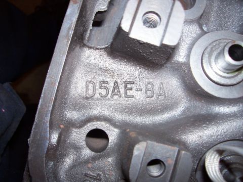 1979 Ford Bronco - A close-up view of a dark metal engine component displaying the casting numbers D5AE-BA.