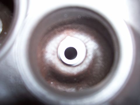 1979 Ford Bronco - Close-up view of a cylinder head valve seat, showing internal wear marks.
