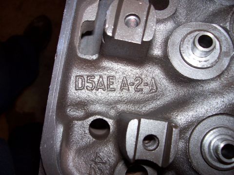 1979 Ford Bronco - This is a close-up view of a cast iron engine cylinder head, showing stamped identification numbers.