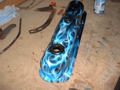 1978 Ford Mustang II - A custom-painted valve cover with a flame design sits on a cluttered workbench next to a can of soda.