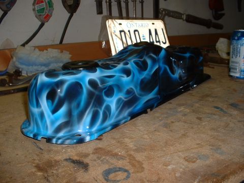 1978 Ford Mustang II - A custom airbrushed valve cover with blue flames sits on a workbench next to an Ontario license plate.