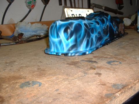 1978 Ford Mustang II - Custom painted oil pan with flame graphics sits on a wooden workbench.