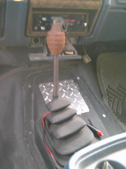 1986 Ford Bronco - The interior of a 1986 Ford Bronco features a grenade used as a shift knob.