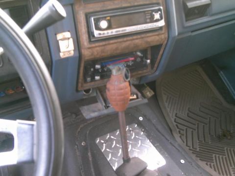 1986 Ford Bronco - Vehicle interior features a grenade-shaped shift knob and aftermarket radio.