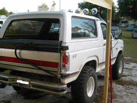 1986 Ford Bronco - This 1986 Ford Bronco features off-road tires and auxiliary lights mounted on the roof.