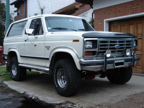 1986 Ford Bronco - This 1986 Ford Bronco is shown in a 3/4 front view, parked in front of a brick garage.